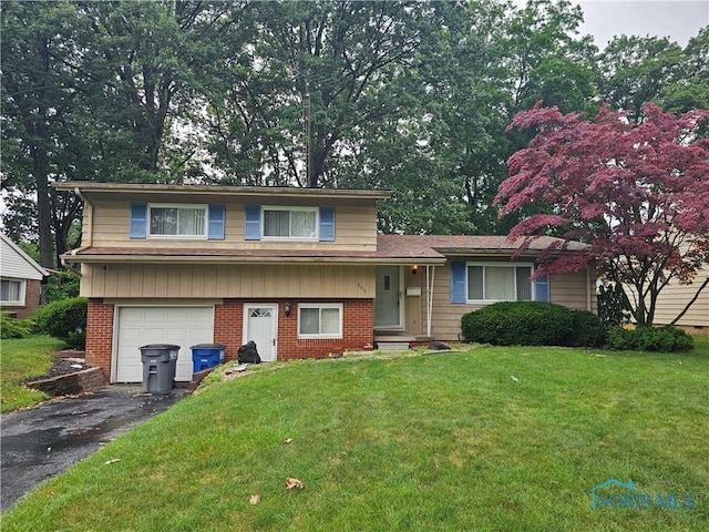 6031 Benalex Dr, Toledo, OH 43612 - tri-level home featuring a garage, driveway, a front lawn, and brick siding