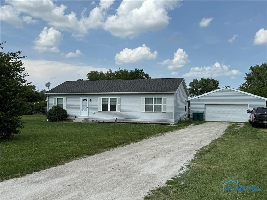 23255 State Route 51, Genoa, OH 43430 - view of front facade featuring a garage, an outbuilding, and a front yard
