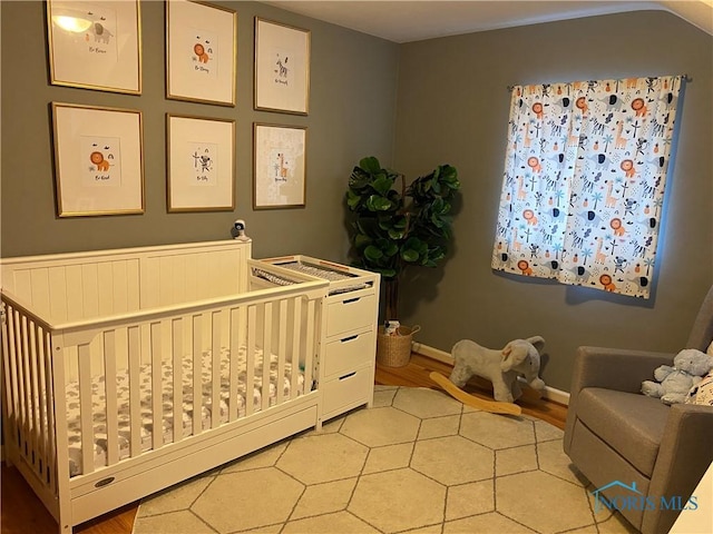 2950 Darlington Rd, Toledo, OH 43606 - bedroom with light wood-style floors and a crib