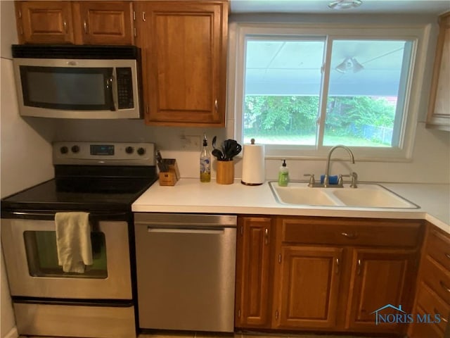 2950 Darlington Rd, Toledo, OH 43606 - kitchen with appliances with stainless steel finishes, brown cabinets, and light countertops