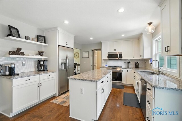 845 Oak Knoll Dr, Perrysburg, OH 43551 - kitchen with appliances with stainless steel finishes, backsplash, a kitchen island, white cabinets, and recessed lighting