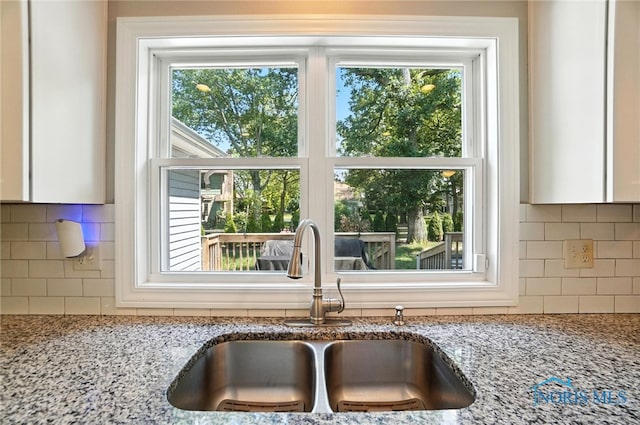 845 Oak Knoll Dr, Perrysburg, OH 43551 - kitchen view of light stone countertops, decorative backsplash, and white cabinetry