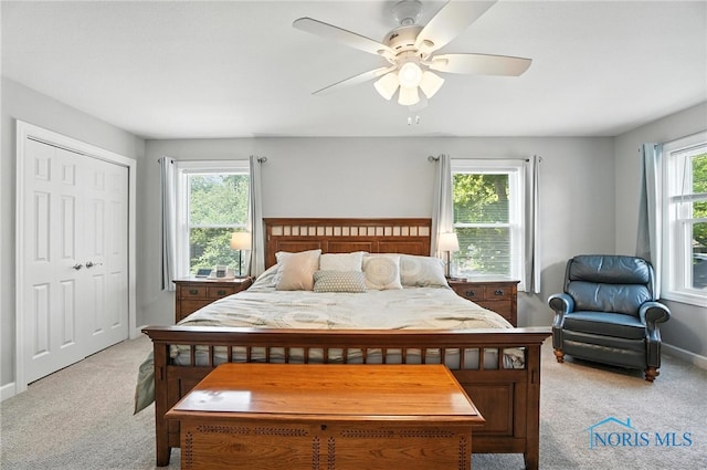 845 Oak Knoll Dr, Perrysburg, OH 43551 - bedroom with light colored carpet, ceiling fan, and a closet