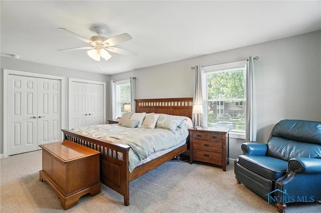 845 Oak Knoll Dr, Perrysburg, OH 43551 - bedroom with light colored carpet, two closets, and ceiling fan
