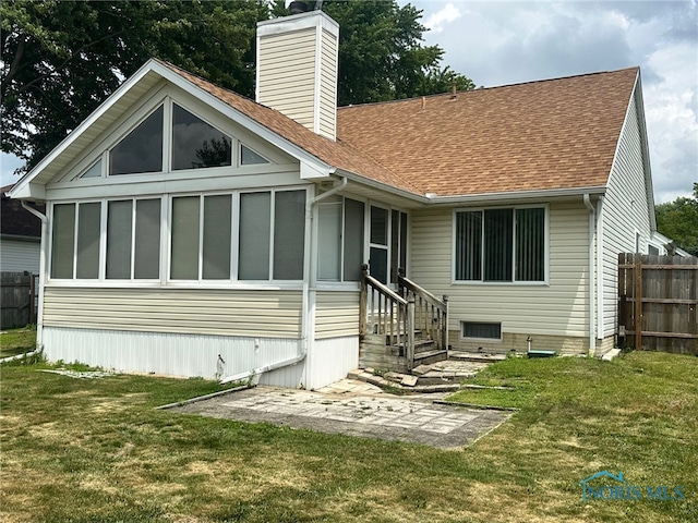 4125 Meadow Green Dr, Sylvania, OH 43560 - rear view of house with a shingled roof, a chimney, and a sunroom