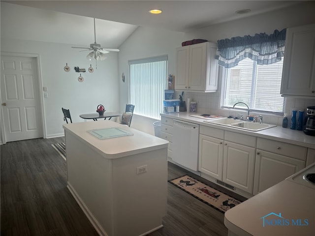 4125 Meadow Green Dr, Sylvania, OH 43560 - kitchen with white dishwasher, a center island, tasteful backsplash, dark wood finished floors, and vaulted ceiling