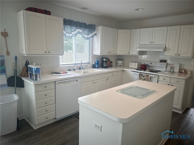 4125 Meadow Green Dr, Sylvania, OH 43560 - kitchen with white appliances, under cabinet range hood, tasteful backsplash, and dark wood finished floors