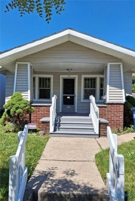 516 Lodge Ave, Toledo, OH 43609 - view of front of home featuring brick siding and a porch