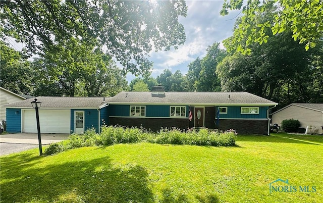 714 Westwood Dr, Defiance, OH 43512 - single story home with a garage, concrete driveway, a front lawn, a chimney, and board and batten siding