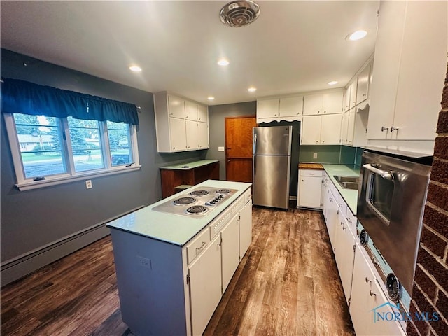 714 Westwood Dr, Defiance, OH 43512 - kitchen with freestanding refrigerator, electric cooktop, dark wood-style floors, white cabinets, and a center island