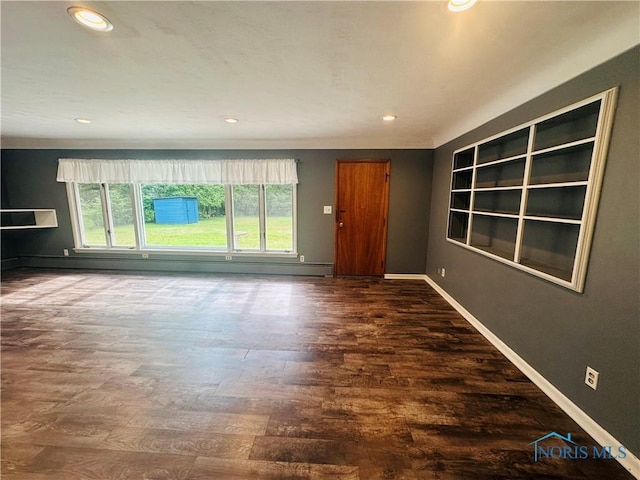 714 Westwood Dr, Defiance, OH 43512 - unfurnished living room featuring wood finished floors, recessed lighting, and a baseboard heating unit