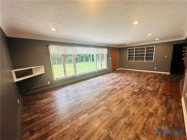 714 Westwood Dr, Defiance, OH 43512 - unfurnished living room featuring wood finished floors, recessed lighting, and a baseboard heating unit