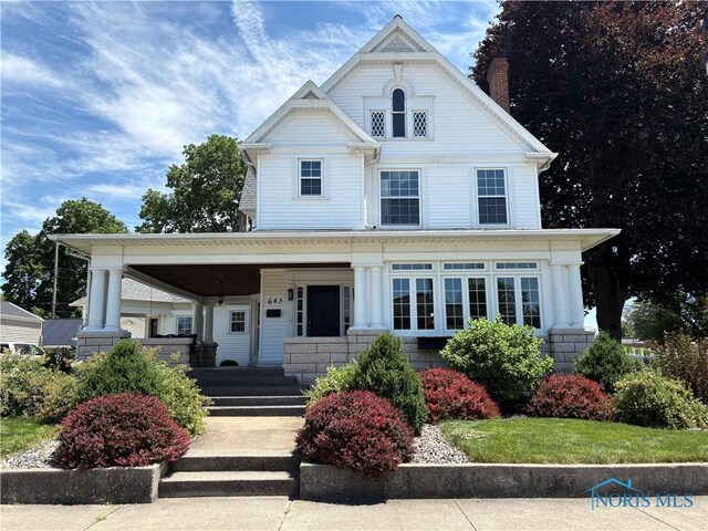 643 S Clinton St, Defiance, OH 43512 - victorian house with covered porch and a chimney