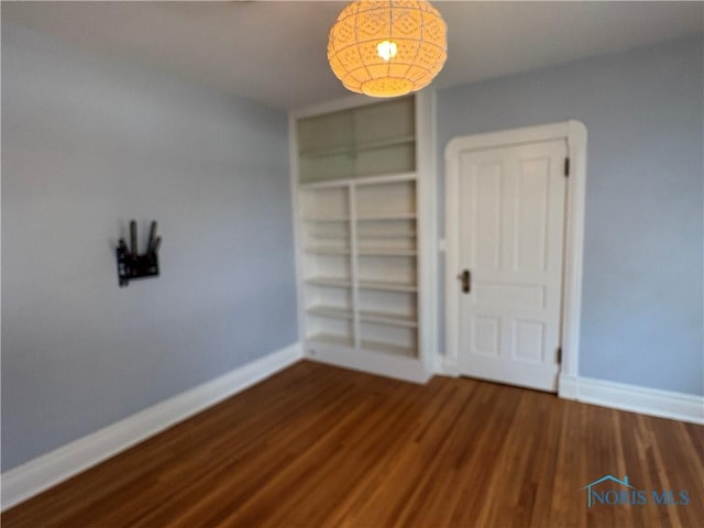 643 S Clinton St, Defiance, OH 43512 - unfurnished bedroom with baseboards and wood finished floors