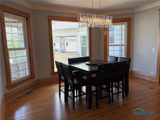 643 S Clinton St, Defiance, OH 43512 - dining area with a chandelier, dark wood-style flooring, and ornamental molding
