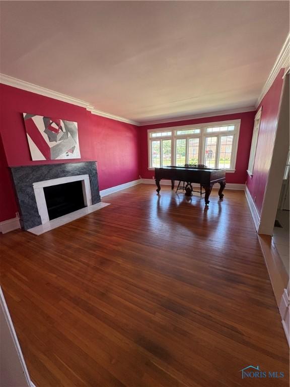 643 S Clinton St, Defiance, OH 43512 - recreation room with crown molding, wood finished floors, billiards, and a high end fireplace