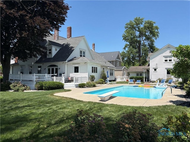 643 S Clinton St, Defiance, OH 43512 - swimming pool featuring a diving board, a yard, a patio area, and a wooden deck