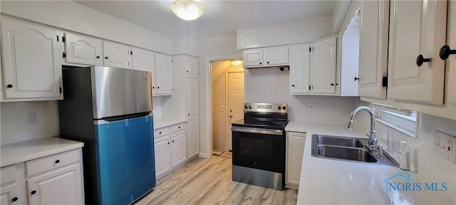 2550 Secor Rd, Toledo, OH 43606 - kitchen featuring appliances with stainless steel finishes, white cabinetry, light wood-style floors, and light countertops