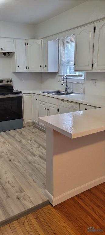 2550 Secor Rd, Toledo, OH 43606 - kitchen featuring electric stove, light countertops, white cabinetry, light wood-type flooring, and dishwasher