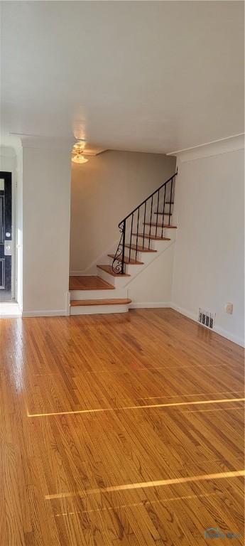2550 Secor Rd, Toledo, OH 43606 - unfurnished living room featuring stairway and wood finished floors