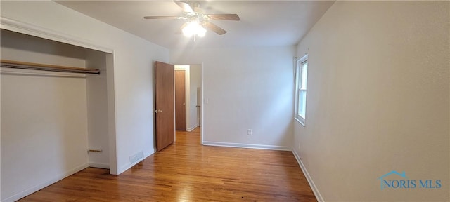 2550 Secor Rd, Toledo, OH 43606 - unfurnished bedroom with wood finished floors, a closet, and a ceiling fan