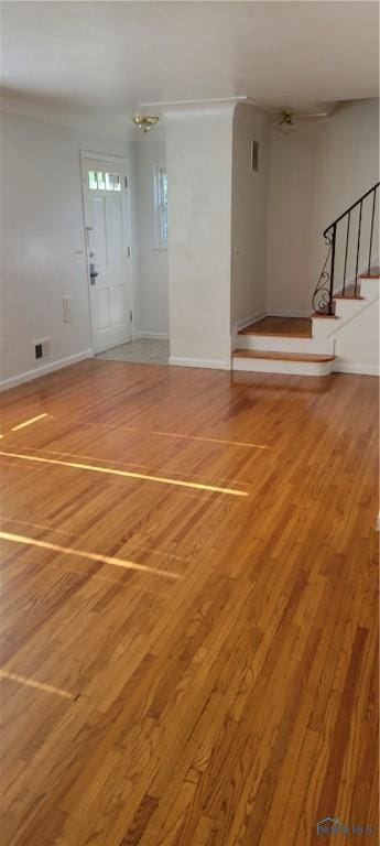 2550 Secor Rd, Toledo, OH 43606 - unfurnished living room featuring light wood-style floors and stairway