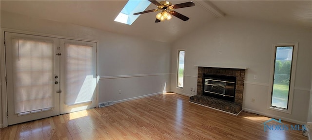 2550 Secor Rd, Toledo, OH 43606 - unfurnished living room featuring a ceiling fan, french doors, wood finished floors, and a skylight