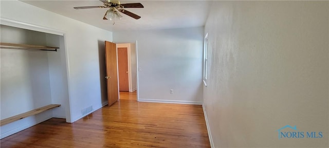 2550 Secor Rd, Toledo, OH 43606 - unfurnished bedroom featuring wood finished floors, a closet, and a ceiling fan