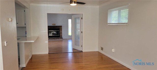 2550 Secor Rd, Toledo, OH 43606 - unfurnished dining area featuring wood finished floors, a ceiling fan, and a glass covered fireplace