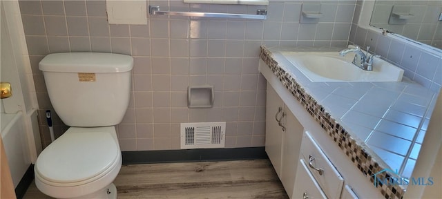 2550 Secor Rd, Toledo, OH 43606 - bathroom with tile walls, vanity, and wood finished floors