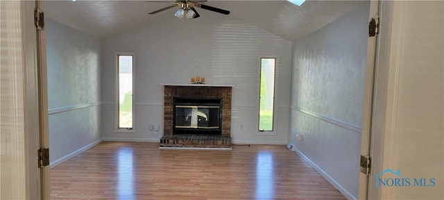 2550 Secor Rd, Toledo, OH 43606 - unfurnished living room with lofted ceiling, wood finished floors, a ceiling fan, and a brick fireplace