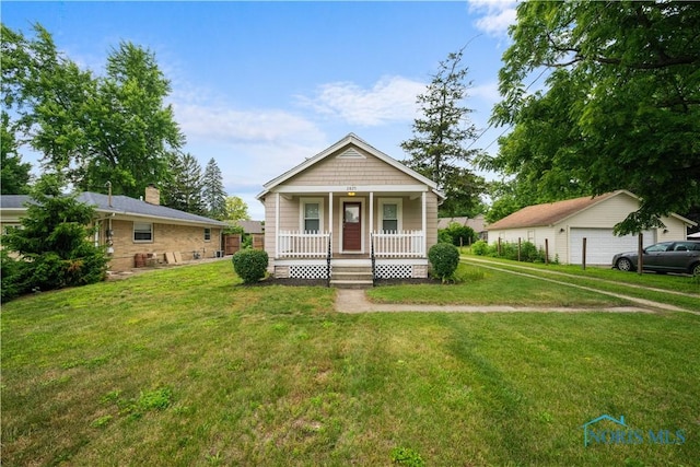 2825 N Mccord Rd, Toledo, OH 43615 - view of front of home with a porch, a front lawn, and a garage