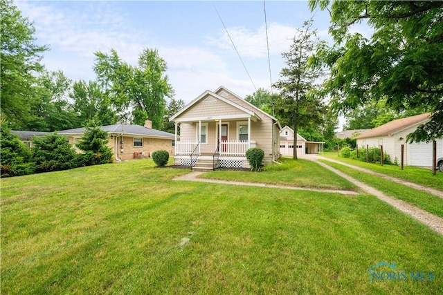 2825 N Mccord Rd, Toledo, OH 43615 - bungalow-style home featuring a porch, a garage, and a front lawn