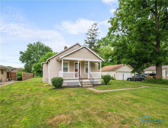 2825 N Mccord Rd, Toledo, OH 43615 - bungalow with a porch, a chimney, and a detached garage