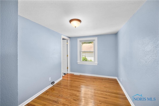 2825 N Mccord Rd, Toledo, OH 43615 - empty room featuring wood finished floors and baseboards