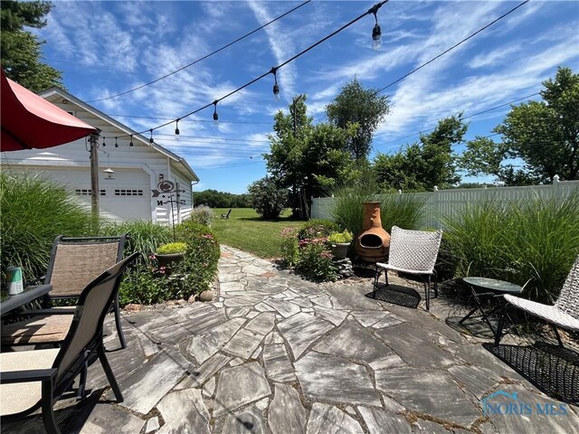 2225 Power Dam Rd, Defiance, OH 43512 - view of patio with an outdoor structure and a garage
