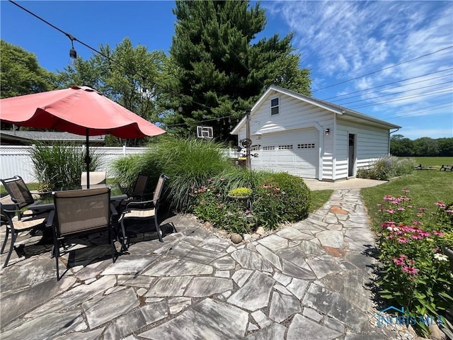 2225 Power Dam Rd, Defiance, OH 43512 - view of patio with an outbuilding, a detached garage, and outdoor dining area