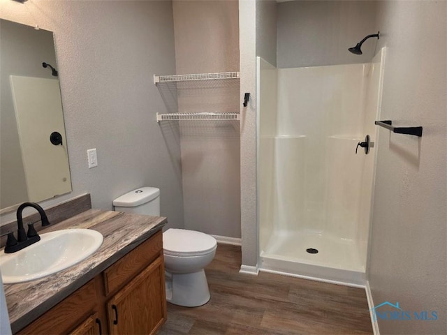 1311 Fitchland Ave, Toledo, OH 43606 - bathroom featuring wood finished floors, walk in shower, and vanity