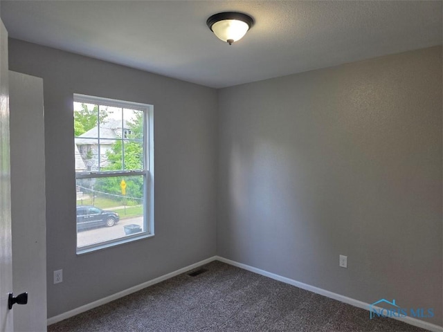 1311 Fitchland Ave, Toledo, OH 43606 - spare room featuring dark colored carpet and baseboards