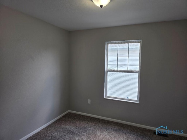 1311 Fitchland Ave, Toledo, OH 43606 - spare room with dark carpet and baseboards