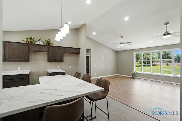 kitchen featuring vaulted ceiling, dark brown cabinetry, ceiling fan, light wood-style floors, and recessed lighting