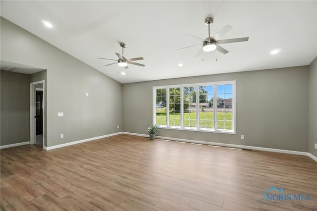 unfurnished room featuring a ceiling fan, lofted ceiling, wood finished floors, and recessed lighting