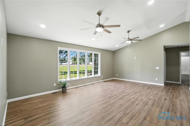 spare room featuring lofted ceiling, ceiling fan, wood finished floors, and recessed lighting