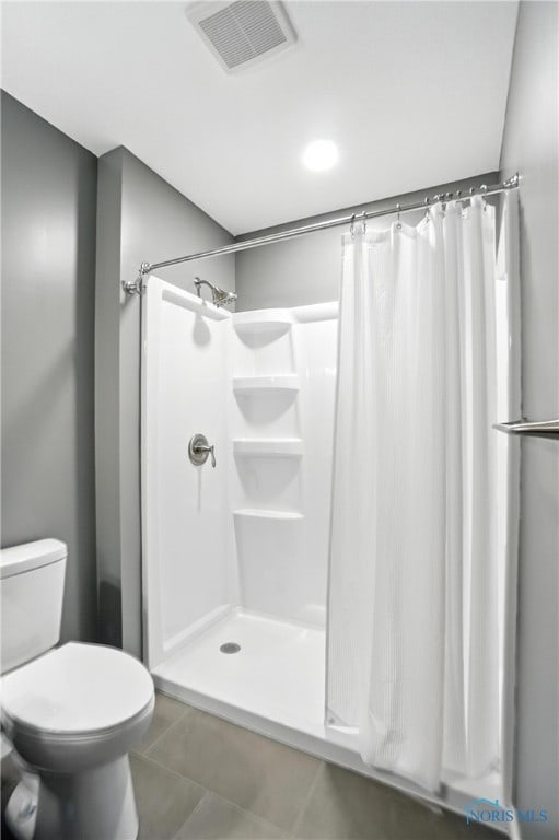 bathroom featuring tile patterned floors and curtained shower