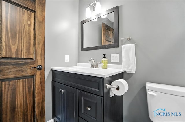 bathroom featuring vanity and toilet