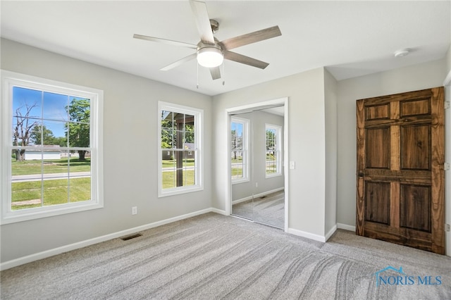 unfurnished bedroom featuring carpet and a ceiling fan