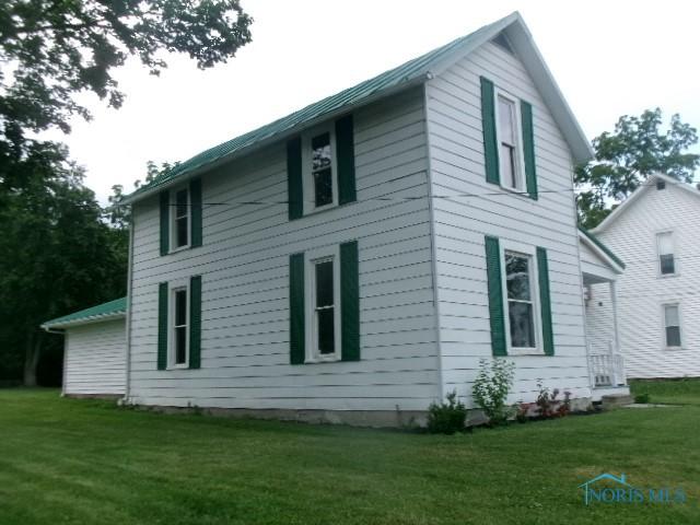 530 N Taft Ave, Ottawa, OH 45875 - view of property exterior with a lawn and a metal roof