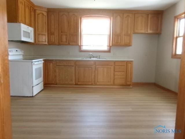 530 N Taft Ave, Ottawa, OH 45875 - kitchen with white appliances, light wood-style floors, and light countertops