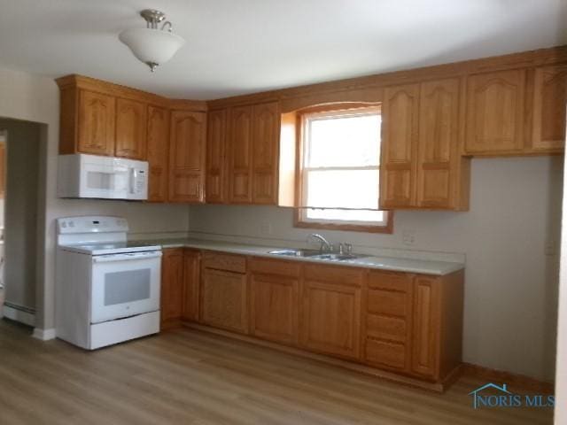 530 N Taft Ave, Ottawa, OH 45875 - kitchen featuring white appliances, light countertops, light wood-style floors, and a baseboard heating unit
