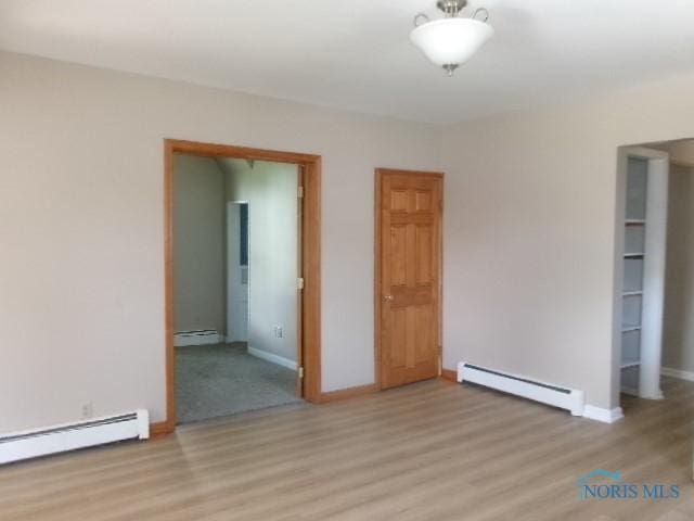 530 N Taft Ave, Ottawa, OH 45875 - unfurnished room with a baseboard heating unit, baseboard heating, and light wood finished floors